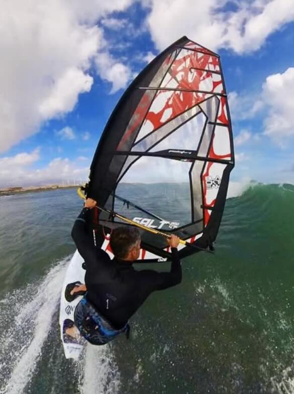 Josep Pons windsurfing on a body of water with a clear sky