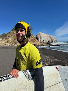 Ben Neumann adaptive surfer with BbTalkin waterproof communication system and surfboard
